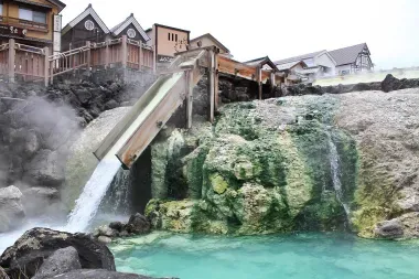 Water pouring into a outdoor cooling pool in Kasatsu Onsen