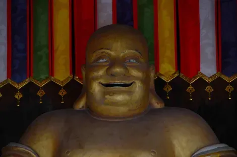 Miroku Buddha, also known as the Laughing Buddha belly fat at Manpukuji Temple (Kyoto).