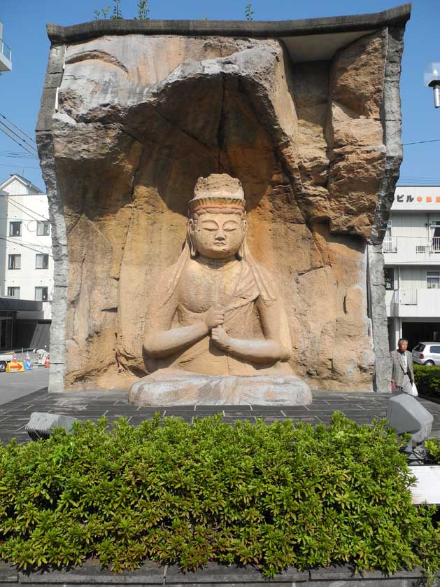 Stone Buddha replica in front of Usuki Station. Usuki is famous for its real ancient stone Buddha sculptures.