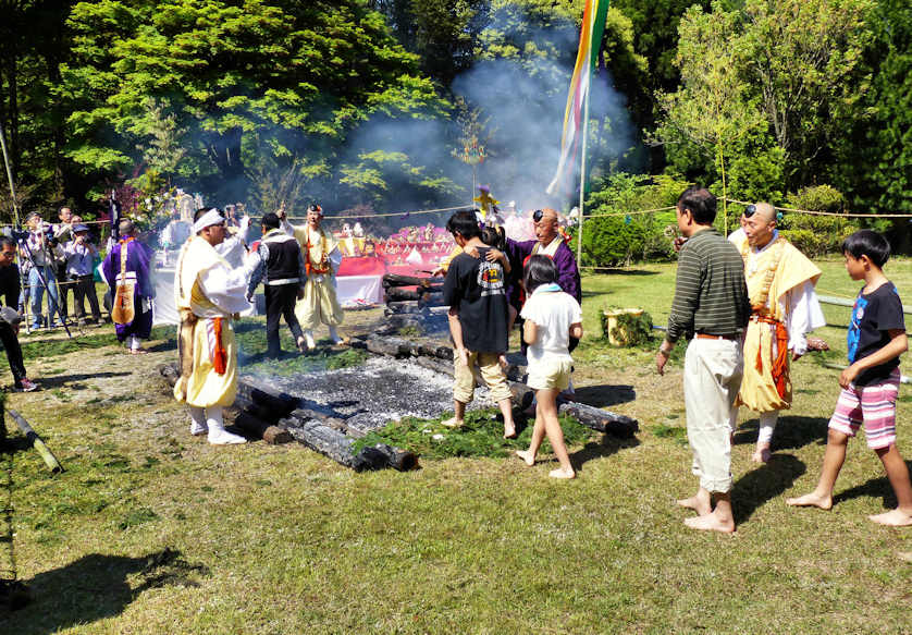 Following a goma ritual yamabushi lead attendees in some fire walking.