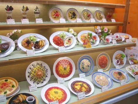 Some plastic food in a restaurant window, showing what's on the menu.