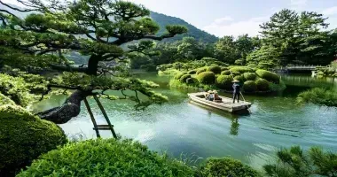 Visitors in a boat visiting a Japanese garden